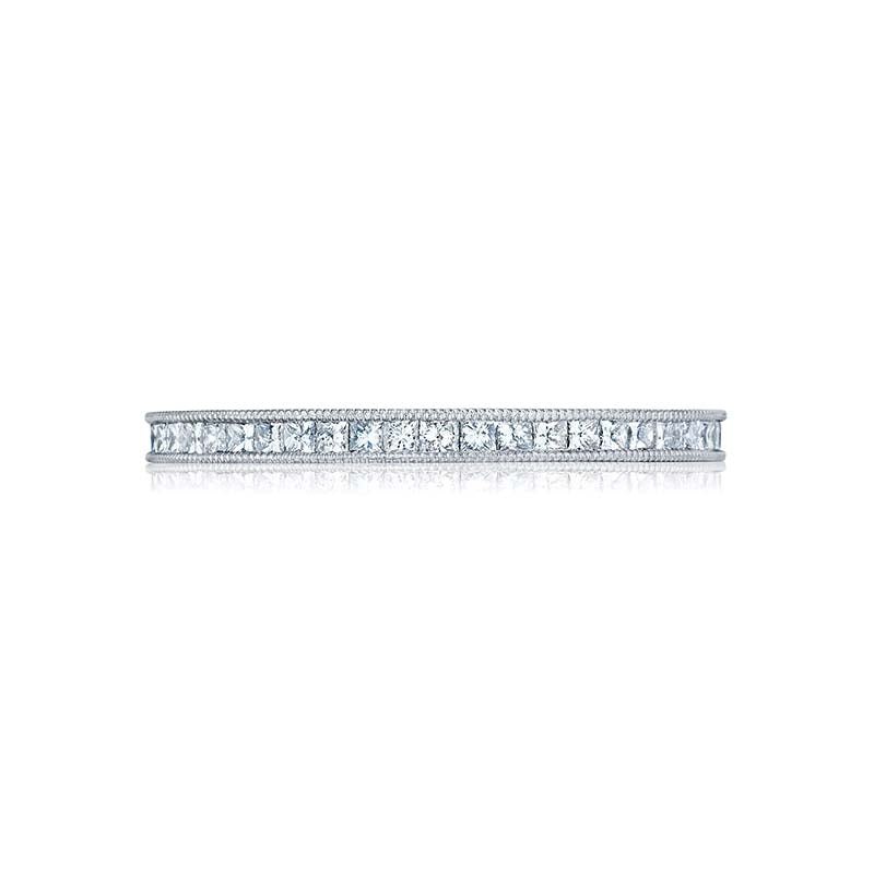 A single; pure row of bright channel set princess cut diamonds link in an eternal circle; with lace-like crescents and milgrain detail on both sides.Total Carats in wedding ring as pictured equal approximately  0.6Metal Shown: Platinum